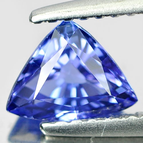 Natural Blue Tanzanite Gemstones 0.93Ct. Clean Trilliant Shape 7 x 5.6 Mm.: Product ID: 807006017 Product Name: Natural Tanzanite Weight: 0.93 CT. Size: 7 x 5.6 x 4 MM. Shape: Trilliant Color: Violetish Blue Clarity:IF Luster: Very Good Gems Origin: Tanzania Treatment: Heated