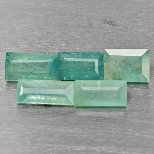 Natural Green Blueish Grandidierite Gemstones 4.07 Ct. 5 Pcs. Baguette Shape and Mixed Size: Product ID: 803100040 Product Name: Natural Magnet Weight: 4.07 CT. Size: 8.5 x 3.5 x 2.8 to 6.8 x 4.9 x 3.8 MM. Shape: Baguette Color: Green Blueish Clarity:SI1 Luster: Good Gems Origin: Madagascar T