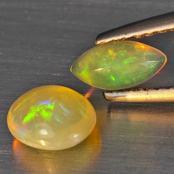 Natural Multi Color Play Of Colour Opal Gemstones 0.94 Ct. 2 Pcs. Mixed Cabochon Shape 7.5 x 4.5 Mm.: Product ID: 818728368 Product Name: Natural Opal Weight: 0.94 CT. Size: 7.5 x 4.5 x 2.2 to 7.2 x 6.2 x 3.8 MM. Shape: Mixed Shape Color: Multi-Color Clarity:None Luster: Good Gems Origin: Ethiopia Tre