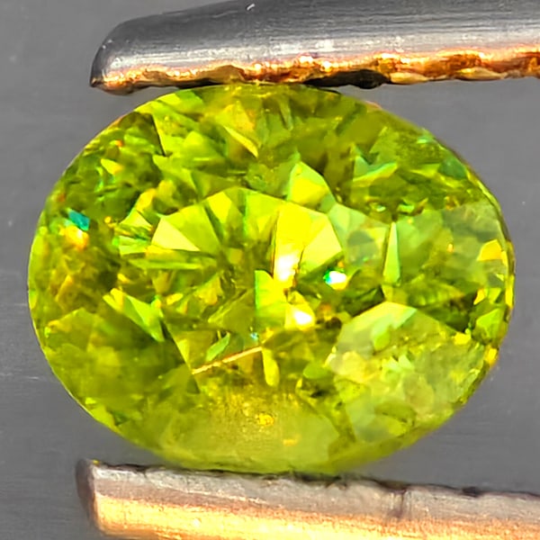 Natural Multi-Color With Rainbow Spark Sphene Gemstones 0.63 Ct. Oval Shape 5.4 x 4.4 Mm.: Product ID: 806509275 Product Name: Natural Sphene Weight: 0.63 CT. Size: 5.4 x 4.4 x 4.2 MM. Shape: Oval Color: Multi-Color Clarity:SI1 Luster: Good Gems Origin: Madagascar Treatment: Unheated Crysta
