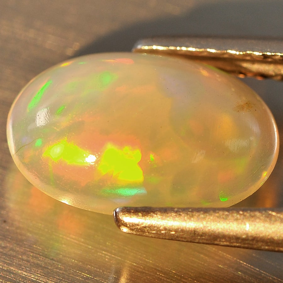 Natural Multi Color Opal Gemstones 1.22 Ct. Oval Cabochon Shape 10.9 x 7.2 Mm.: Product ID: 818713104 Product Name: Natural Opal Weight: 1.22 CT. Size: 10.9 x 7.2 x 3.2 MM. Shape: Oval Cabochon Color: Multi Color Clarity:Semi - Transparent Luster: Good Gems Origin: Ethiopia Treat