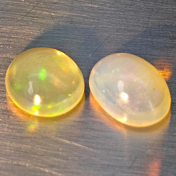 Natural Multi-Color Play Of Colour Opal Gemstones 1.37 Ct. 2 Pcs. Oval Cabochon Shape 7.7 x 5.7 Mm.: Product ID: 818728289 Product Name: Natural Opal Weight: 1.37 CT. Size: 7.7 x 5.7 x 4.2 MM. Shape: Oval Cabochon Color: Multi-Color Clarity:None Luster: Good Gems Origin: Ethiopia Treatment: Unheated 