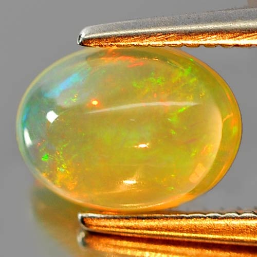 Natural Multi Color Play Of Colour Opal Gemstones 0.81 Ct. Oval Cabochon Shape 8 x 5.9 Mm.: Product ID: 818726314 Product Name: Natural Opal Weight: 0.81 CT. Size: 8 x 5.9 x 3.8 MM. Shape: Oval Cabochon Color: Multi Color Clarity:Semi - Transparent Luster: Iridescent Gems Origin: Ethiopia Tr