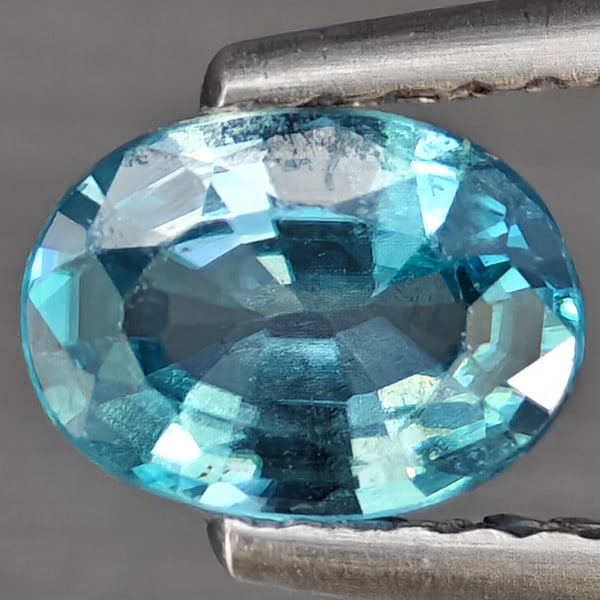 Natural Blue Zircon Gemstones 0.82 Ct. Oval Shape 6.8 x 5 Mm.: Product ID: 807743214 Product Name: Natural Tanzanite Weight: 0.82 CT. Size: 6.8 x 5 x 2.7 MM. Shape: Oval Shape Color: Blue Clarity:SI1 Luster: Good Gems Origin: Cambodia Treatment: Heated Crystal St