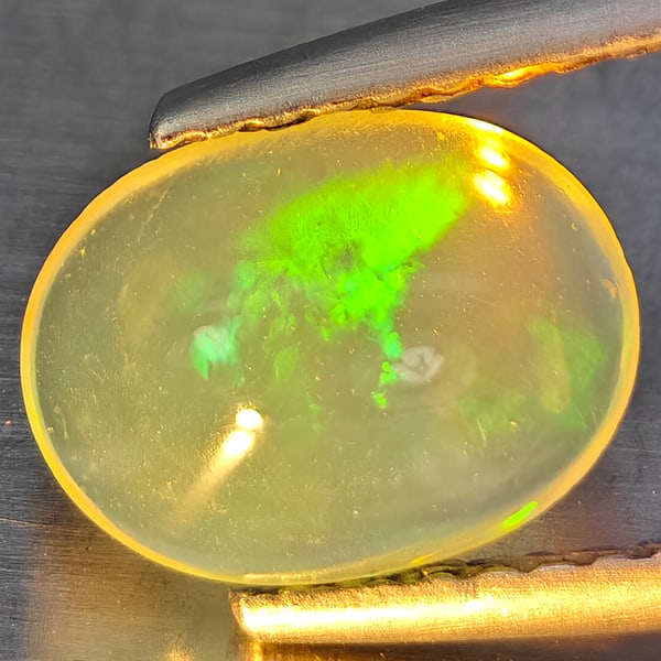 Natural Multi-Color Play Of Colour Opal Gemstones 1.15 Ct. Oval Cabochon Shape 9 x 6.8 Mm.: Product ID: 818728296 Product Name: Natural Opal Weight: 1.15 CT. Size: 9 x 6.8 x 4 MM. Shape: Oval Cabochon Color: Multi-Color Clarity:None Luster: Good Gems Origin: Ethiopia Treatment: Unheated Crys