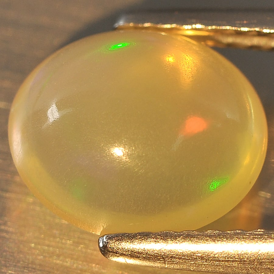 Natural Multi Color Opal Gemstones 1.70 Ct. Oval Cabochon Shape 9.4 x 8.2 Mm.: Product ID: 818708538 Product Name: Natural Opal Weight: 1.70 CT. Size: 9.4 x 8.2 x 4.7 MM. Shape: Oval Cabochon Color: Multi Color Clarity:Semi - Transparent Luster: Good Gems Origin: Ethiopia Treatm