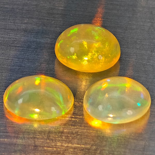 Natural Multi-Color Opal Gemstones 1.58 Ct. 3 Pcs. Oval Cabochon Shape 6.2 x 5.2 Mm.: Product ID: 818728305 Product Name: Natural Opal Weight: 1.58 CT. Size: 6.2 x 5.2 x 4 MM. Shape: Oval Cabochon Color: Multi-Color Clarity:None Luster: Good Gems Origin: Ethiopia Treatment: Unheated Cr