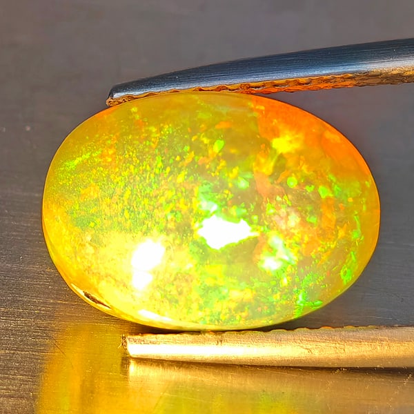 Natural Multi-Color Opal Gemstone 3.97 Ct. Oval Cabochon Shape 12 x 8.8 Mm.: Product ID: 708700135 Product Name: Natural Opal Weight: 3.97 CT. Size: 12 x 8.8 x 7.4 MM. Shape: Oval Cabochon Color: Multi-Color Clarity:Opaque Luster: Strong Iridescent Gems Origin: Ethiopia Treatm