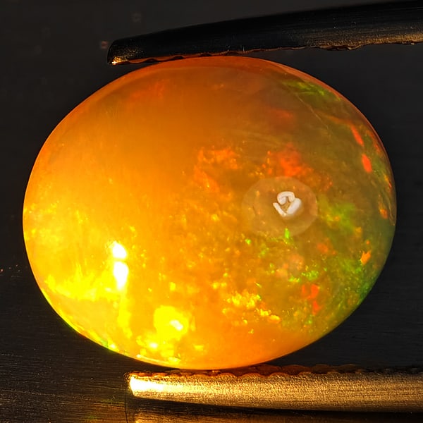 Natural Multi-Color Play Of Colour Opal Gemstone 2.22 Ct. Oval Cabochon Shape 10 x 8 Mm.: Product ID: 708700111 Product Name: Natural Opal Weight: 2.22 CT. Size: 10 x 8 x 5.3 MM. Shape: Oval Cabochon Color: Multi-Color Clarity:Opaque Luster: Good Gems Origin: Ethiopia Treatment: Unheated C