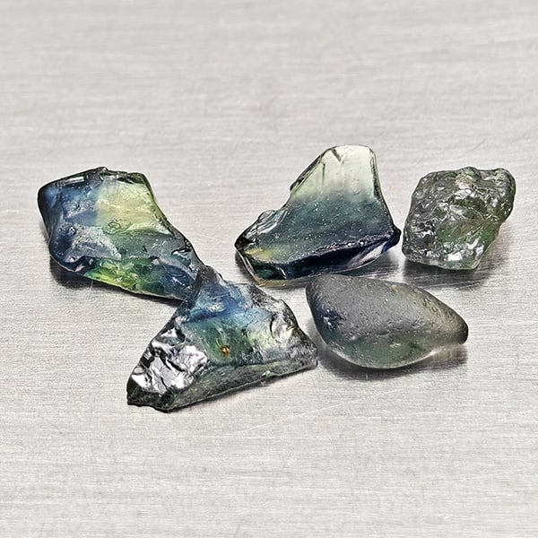 Natural Greenish Blue Sapphire Gemstones 2.38 Ct. 5 Pcs. Rough Shape: Product ID: 806162542 Product Name: Natural Green Sapphire Weight: 2.38 CT. Size: 5.1 x 4.1 x 3.1 to 8.2 x 4.3 x 2.2 MM. Shape: Rough Mixed Shape Color: Greenish Blue Clarity:VSI Luster: Good Gems Ori