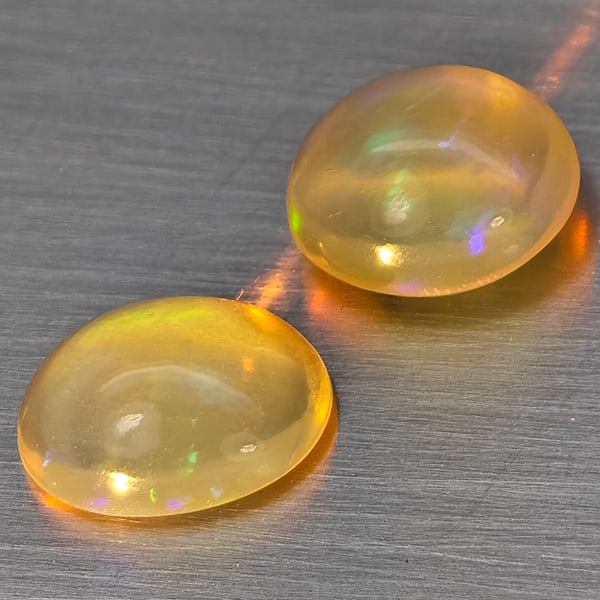 Natural Multi Color Play Of Colour Opal Gemstones 1.60 Ct. 2 Pcs. Oval Cabochon Shape 7.8 x 6.4 Mm.: Product ID: 818728361 Product Name: Natural Opal Weight: 1.60 CT. Size: 7.8 x 6.4 x 3.4 MM. Shape: Oval Cabochon Color: Multi-Color Clarity:None Luster: Good Gems Origin: Ethiopia Treatment: Unheated 