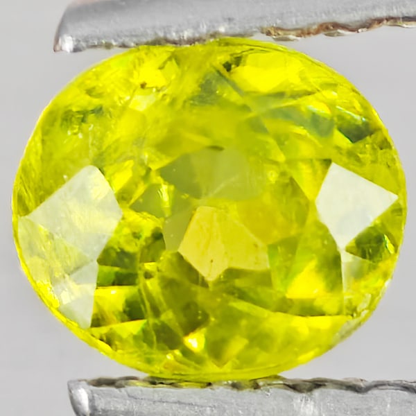 Natural Multi-Color With Rainbow Spark Sphene Gemstones 1.02 Ct. Oval Shape 6.1 x 5.4 Mm.: Product ID: 806509178 Product Name: Natural Sphene Weight: 1.02 CT. Size: 6.1 x 5.4 x 4 MM. Shape: Oval Shape Color: Multi-Color With Rainbow Spark Clarity:SI1 Luster: Good Gems Origin: Madagascar Tre