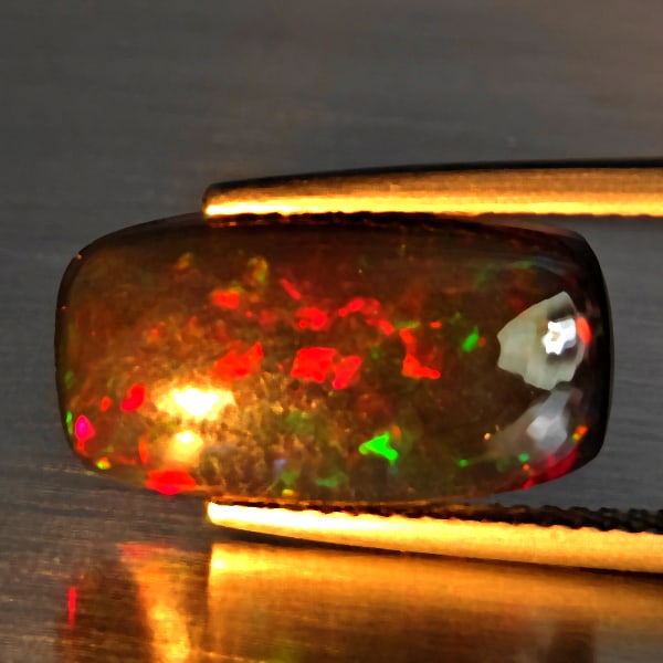 Natural Multi Color Play Of Colour Opal Gemstones 2.81 Ct. Cushion Cabochon Shape 16.3 x 8.9 Mm.: Product ID: 818728447 Product Name: Natural Opal Weight: 2.81 CT. Size: 16.3 x 8.9 x 3.5 MM. Shape: Cushion Cabochon Color: Multi-Color Clarity:Semi - Transparent Luster: Good Gems Origin: Ethiopia Tr