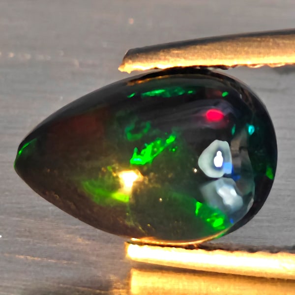 Natural Multi Color Play Of Colour Opal Gemstones 1.33 Ct. Pear Cabochon Shape 10.6 x 7.2 Mm.: Product ID: 818728538 Product Name: Natural Opal Weight: 1.33 CT. Size: 10.6 x 7.2 x 4.2 MM. Shape: Pear Cabochon Color: Multi-Color Clarity:Semi - Transparent Luster: Good Gems Origin: Ethiopia Treat