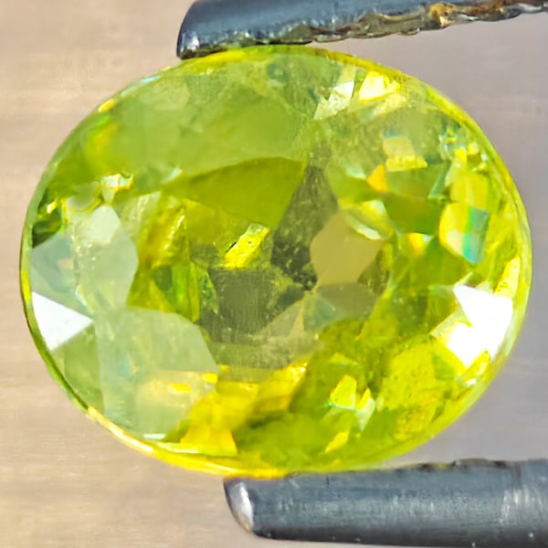 Natural Multi-Color Sphene With Rainbow Spark Gemstones 1.00 Ct. Oval Shape 6.1 x 5.6 Mm: Product ID: 806509172 Product Name: Natural Sphene Weight: 1.00 CT. Size: 6.1 x 5.6 x 3.8 MM. Shape: Oval Shape Color: Multi-Color With Rainbow Spark Clarity:SI1 Luster: Good Gems Origin: Madagascar T