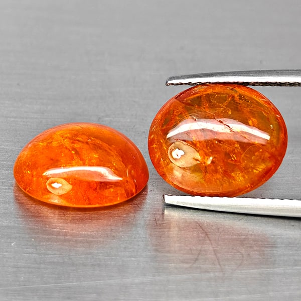 Natural Orangish Red Spessartine Garnet Gemstones 14.39 Ct. 2 Pcs. Oval Cabochon Shape 12.9 x 11.2: Product ID: 802938014 Product Name: Natural Garnet Weight: 14.39 CT. Size: 12.9 x 11.2 x 5.1 to 12.5 x 11 x 4.7 MM. Shape: Oval Cabochon Color: Orangish Red Clarity:SI1 Luster: Good Gems Origin: Namib