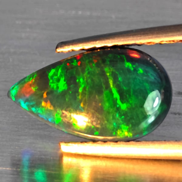 Natural Multi Color Play Of Colour Opal Gemstones 1.16 Ct. Pear Cabochon Shape 12.8 x 7.5 Mm.: Product ID: 818728534 Product Name: Natural Opal Weight: 1.16 CT. Size: 12.8 x 7.5 x 3 MM. Shape: Pear Cabochon Color: Multi-Color Clarity:Semi - Transparent Luster: Good Gems Origin: Ethiopia Treatme