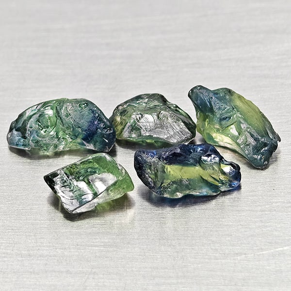 Natural Greenish Blue Sapphire Gemstones 4.79 Ct. 5 Pcs. Rough Shape and Mixed Size: Product ID: 806162526 Product Name: Natural Green Sapphire Weight: 4.79 CT. Size: 7.1 x 5.4 x 3.8 to 8.9 x 3.8 x 3.8 MM. Shape: Rough Mixed Shape Color: Greenish Blue Clarity:VSI Luster: Good Gems Ori