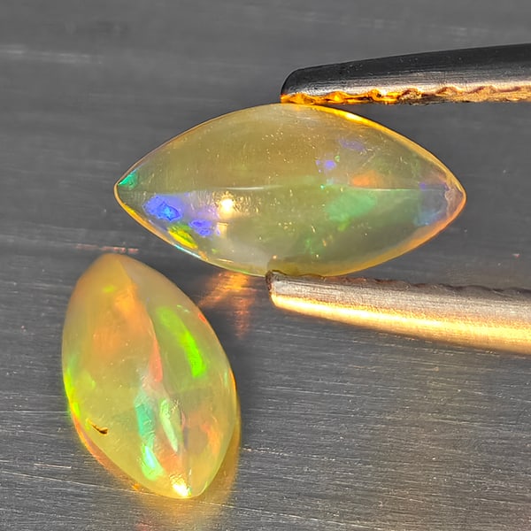 Natural Multi Color Play Of Colour Opal Gemstones 0.26 Ct. 2 Pcs. Marquise Shape Cabochon Shape 7.8: Product ID: 818728349 Product Name: Natural Opal Weight: 0.26 CT. Size: 7.8 x 3.7 x 3 MM. Shape: Marquise Shape Color: Multi-Color Clarity:None Luster: Good Gems Origin: Ethiopia Treatment: Unheated C