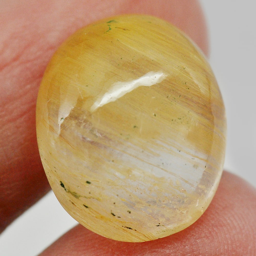 Natural Rutilated Yellow White Quartz Gemstones 15.45 Ct. Oval Cabochon Shape 18.1 x 14.8 Mm.: Product ID: 805529394 Product Name: Natural Quartz Weight: 15.45 CT. Size: 18.1 x 14.8 x 8.2 MM. Shape: Oval Cabochon Color: White Clarity:Semi - Transparent Luster: Good Gems Origin: Thailand Treatme