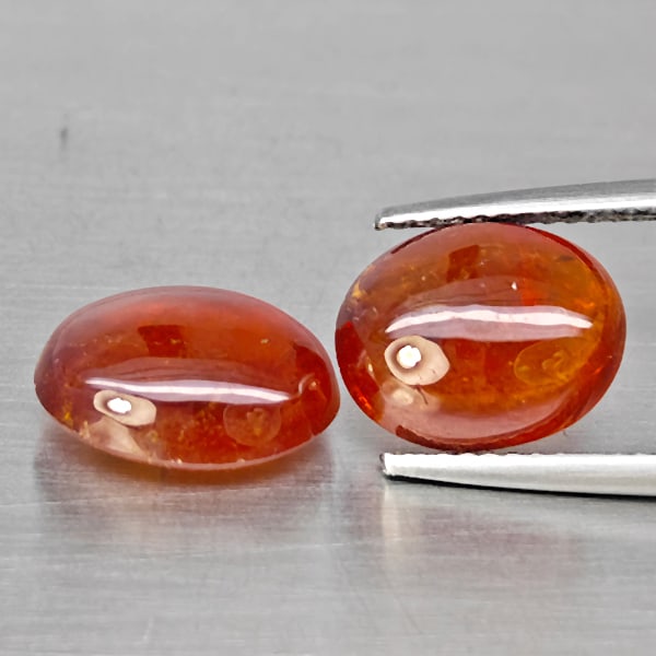 Natural Orangish Red Spessartine Garnet Gemstones 10.27 Ct. 2 Pcs. Oval Cabochon Shape 11.3 x 9.1: Product ID: 802938011 Product Name: Natural Garnet Weight: 10.27 CT. Size: 11.3 x 9.1 x 5.1 to 10.7 x 8.9 x 4.7 MM. Shape: Oval Cabochon Color: Orangish Red Clarity:SI1 Luster: Good Gems Origin: Namib