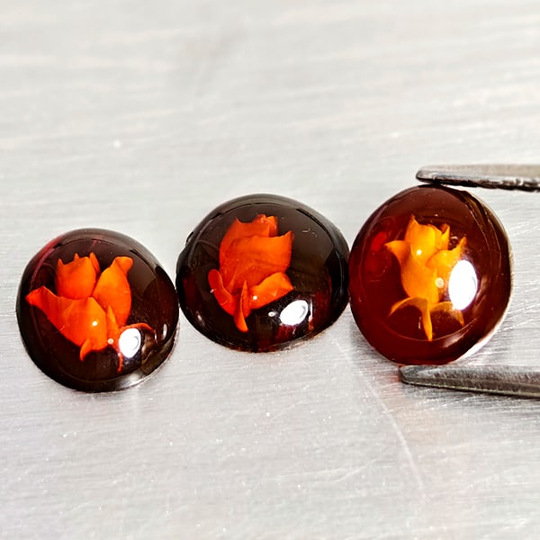 Natural Brown Yellow Amber 1.31 Ct. 3 Pcs. Flower Carving In Oval Cabochon Shape: Product ID: 819091057 Product Name: Natural Amber Weight: 1.31 CT. Size: 8.9 x 7.1 x 2.7 to 8.2 x 7.3 x 2.5 MM. Shape: Oval Cabochon Color: Brown Yellow Clarity:Semi - Transparent Luster: Good Gems Or