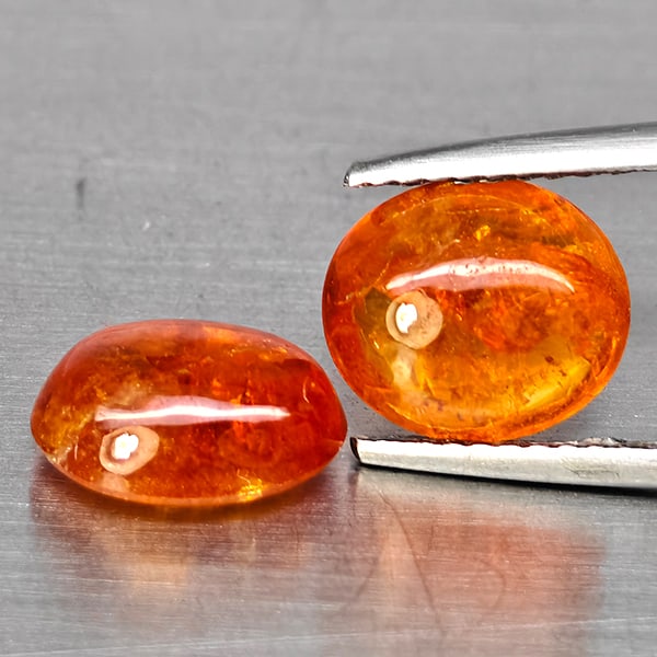 Natural Orangish Red Spessartine Garnet Gemstones 6.57 Ct. 2 Pcs.Oval Cabochon Shape: Product ID: 802938018 Product Name: Natural Garnet Weight: 6.57 CT. Size: 9.5 x 7.6 x 4.4 MM. Shape: Oval Cabochon Color: Orangish Red Clarity:SI1 Luster: Good Gems Origin: Namibia Treatment: Unheated