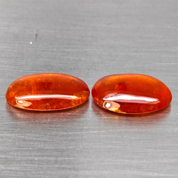 Natural Orangish Red Spessartine Garnet Gemstones 12.56 Ct. 2 Pcs. Oval Cabochon Shape 14.7 x 9.3: Product ID: 802937999 Product Name: Natural Garnet Weight: 12.56 CT. Size: 14.7 x 9.3 x 4.1 to 14 x 10.1 x 4.5 MM. Shape: Oval Cabochon Color: Orangish Red Clarity:SI1 Luster: Good Gems Origin: Namibi