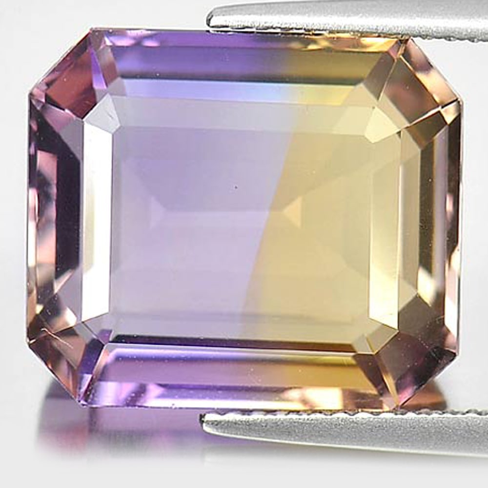 Natural Bi Color Ametrine Gemstones 14.95 Ct. Octagon Shape 15.6 x 13.6 Mm.: Product ID: 800407320 Product Name: Natural Ametrine Weight: 14.95 CT. Size: 15.6 x 13.6 x 8.5 MM. Shape: Octagon Color: Bi-Color Clarity:VVS Luster: Good Gems Origin: Bolivia Treatment: Unheated Crys
