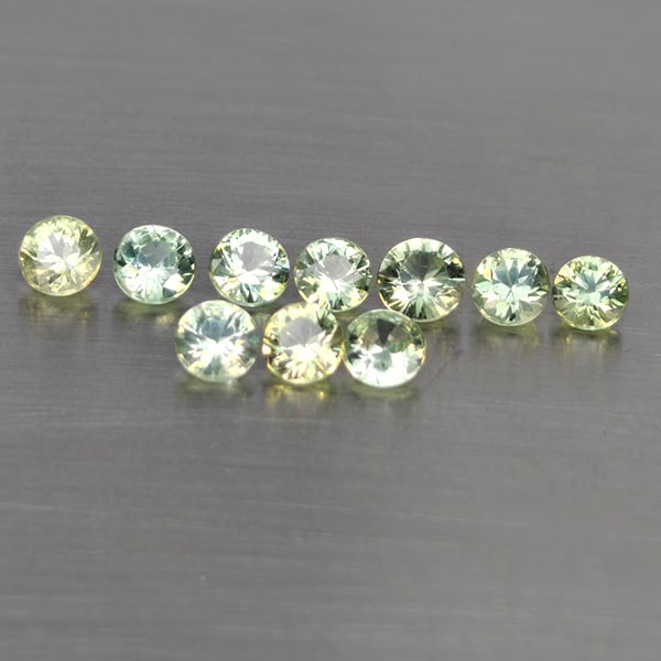 Natural Green Songea Sapphire Gemstones 0.68 Ct. 10 Pcs. Round Diamond Cut 2.6 Mm.: Product ID: 806130518 Product Name: Natural Blue Sapphire Weight: 0.26 CT. Size: 2.6 x 2.6 x 1.7 MM. Shape: Round Diamond Cut Color: Green Clarity:SI1 Luster: Good Gems Origin: Tanzania Treatment: Hea