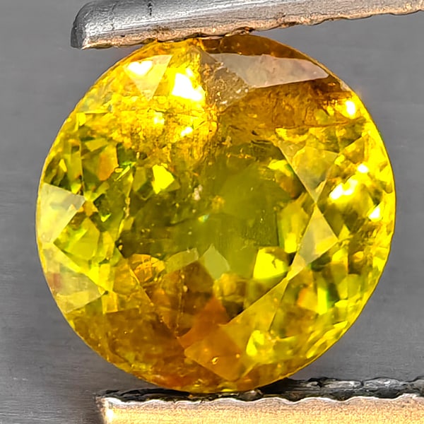 Natural Multi-Color Sphene With Rainbow Spark Gemstones 1.32 Ct. Round Shape 6.8 Mm.: Product ID: 806509124 Product Name: Natural Sphene Weight: 1.32 CT. Size: 6.8 x 6.8 x 4 MM. Shape: Round Shape Color: Multi-Color Clarity:SI1 Luster: Good Gems Origin: Madagascar Treatment: Unheated C