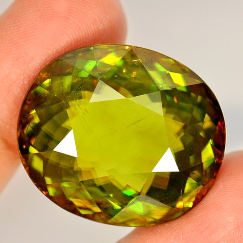 Natural Multi Color Sphene Gemstones With Rainbow Spark 62.90 Ct. Oval Shape 27 x 23 Mm.