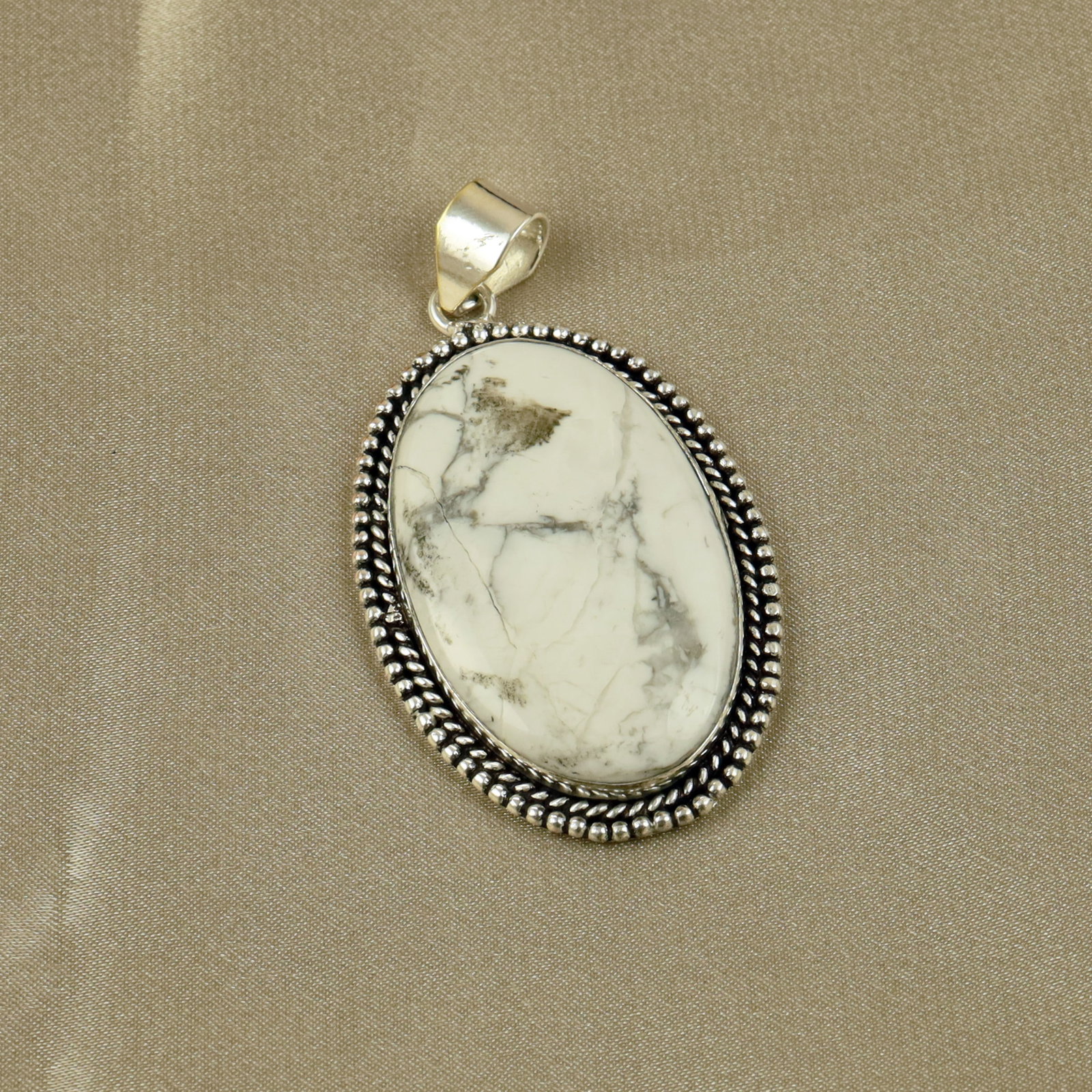 Natural Howlite Sterling Silver Plated Handmade Pendant: Product ID: 260518140646 Product - Handmade Silver Plated Pendant Metal - 92.5 Sterling Silver Plated Pendant Size - 4.5x3CM Gemstone - Howlite Gemstone Origin - Canada Gemstone Shape - Oval Pendant W