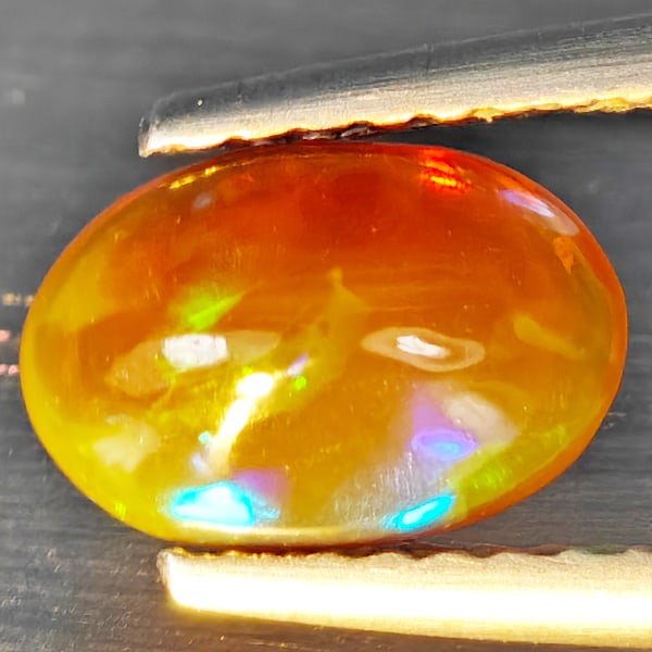 Natural Multi Color Opal Gemstones 0.81 Ct. Oval Cabochon Shape 8.4 x 5.7 Mm.: Product ID: 818728406 Product Name: Natural Opal Weight: 0.81 CT. Size: 8.4 x 5.7 x 3.7 MM. Shape: Oval Cabochon Color: Multi-Color Clarity:Semi - Transparent Luster: Good Gems Origin: Ethiopia Treatm