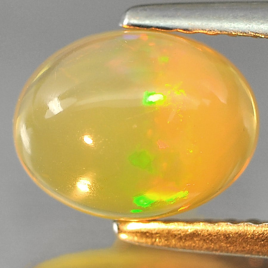 Natural Multi Color Play Of Colour Opal Gemstones 1.53 Ct. Oval Cabochon Shape 9.2 x 7.1 Mm.: Product ID: 818725221 Product Name: Natural Opal Weight: 1.53 CT. Size: 9.2 x 7.1 x 4.9 MM. Shape: Oval Cabochon Color: Multi-Color Clarity:Semi - Transparent Luster: Iridescent Gems Origin: Ethiopia 