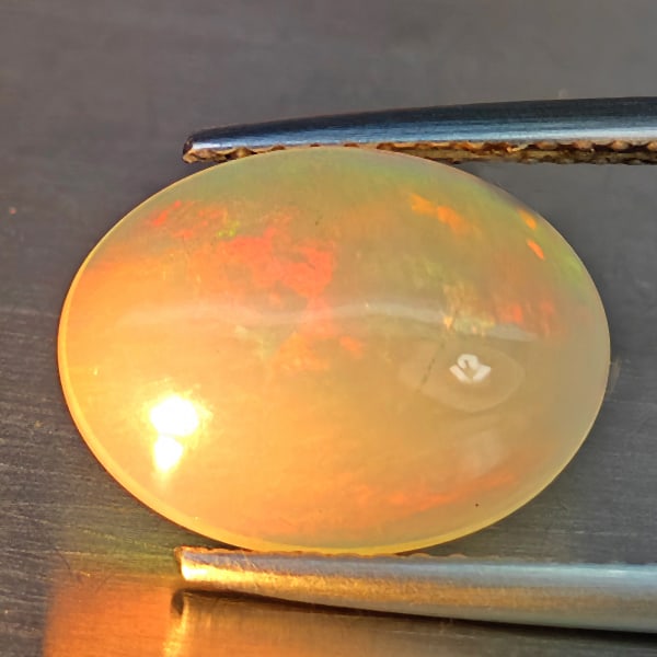 Natural Multi-Color Play Of Colour Opal Gemstone 1.69 Ct. Oval Cabochon Shape 11.6 x 8 Mm.: Product ID: 708700116 Product Name: Natural Opal Weight: 1.69 CT. Size: 11.6 x 8 x 3.5 MM. Shape: Oval Cabochon Color: Multi-Color Clarity:Opaque Luster: Good Gems Origin: Ethiopia Treatment: Unheated