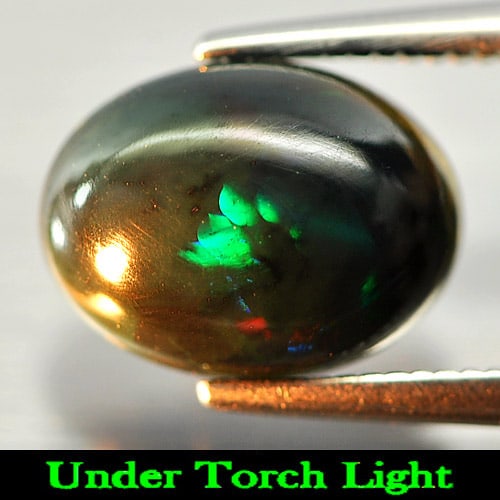 Natural Play Of Color Rainbow Fire Red Black Opal Gemstones 1.29 Ct. Oval Cabochon Shape 10.2 x 7.7: Product ID: 818724475 Product Name: Natural Opal Weight: 1.29 CT. Size: 10.2 x 7.7 x 3.8 MM. Shape: Oval Cabochon Color: Multi-Color Clarity:Semi - Transparent Luster: Iridescent Gems Origin: Ethiopia