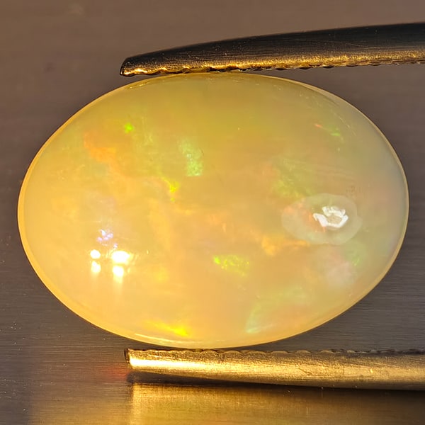 Natural Multi-Color Play Of Colour Opal Gemstone 2.85 Ct. Oval Cabochon Shape 14 x 10 Mm.: Product ID: 708700130 Product Name: Natural Opal Weight: 2.85 CT. Size: 14 x 10 x 4.9 MM. Shape: Oval Cabochon Color: Multi-Color Clarity:Opaque Luster: Good Gems Origin: Ethiopia Treatment: Unheated 