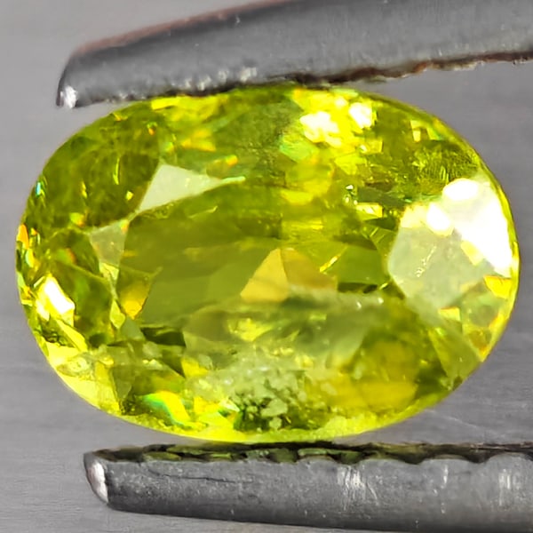 Natural Multi-Color Sphene Gemstones With Rainbow Spark 1.03 Ct. Oval Shape 7 x 5 Mm.: Product ID: 806509230 Product Name: Natural Sphene Weight: 1.03 CT. Size: 7 x 5 x 3.7 MM. Shape: Oval Shape Color: Multi-Color Clarity:SI1 Luster: Good Gems Origin: Madagascar Treatment: Unheated Crys