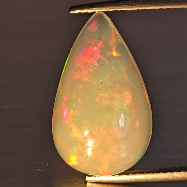 Natural Multi-Color Play Of Colour Opal Gemstone 8.32 Ct. Pear Cabochon Shape 20 x 12.3 Mm.: Product ID: 708700070 Product Name: Natural Opal Weight: 8.32 CT. Size: 20 x 12.3 x 8 MM. Shape: Pear Cabochon Shape Color: Multi-Color Clarity:Opaque Luster: Good Gems Origin: Ethiopia Treatment: Unh