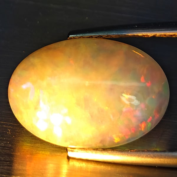 Natural Multi Color Opal Gemstones 3.19 Ct. Oval Cabochon Shape 14.9 x 10.4 Mm.: Product ID: 708700027 Product Name: Natural Opal Weight: 3.19 CT. Size: 14.9 x 10.4 x 5 MM. Shape: Oval Cabochon Color: Multi-Color Clarity:Semi - Transparent Luster: Iridescent Gems Origin: Ethiopia 