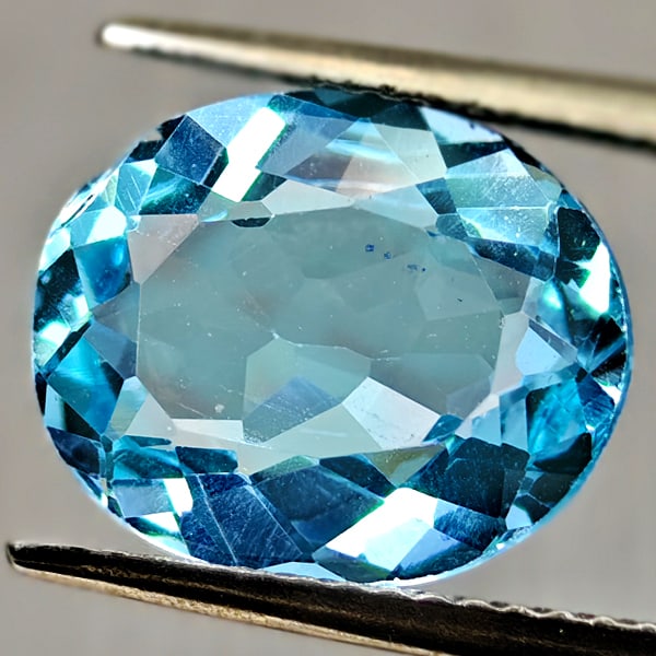 Natural Swiss Blue Topaz Gemstones 5.00 Ct. Oval Shape 12 x 9.9 Mm.: Product ID: 807167912 Product Name: Natural Blue Topaz Weight: 5.00 CT. Size: 12 x 9.9 x 5.2 MM. Shape: Oval Color: Swiss Blue Clarity:VSI Luster: Good Gems Origin: Brazil Treatment: Treated Crystal S