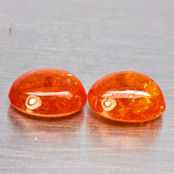 Natural Orangish Red Spessartine Garnet Gemstones 9.34 Ct. 2 Pcs. Oval Cabochon Shape 10.3 x 8.3 Mm.: Product ID: 802938005 Product Name: Natural Garnet Weight: 9.34 CT. Size: 10.3 x 8.3 x 5.5 MM. Shape: Oval Cabochon Color: Orangish Red Clarity:SI1 Luster: Good Gems Origin: Namibia Treatment: Unheate