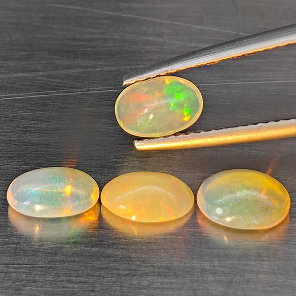 Natural Multi Color Opal Gemstones 2.14 Ct. 4 Pcs. Oval Cabochon Shape 7.5 x 5.6 Mm.: Product ID: 818728419 Product Name: Natural Opal Weight: 2.14 CT. Size: 7.5 x 5.6 x 3.3 MM. Shape: Oval Cabochon Color: Multi-Color Clarity:Semi - Transparent Luster: Good Gems Origin: Ethiopia Treatm