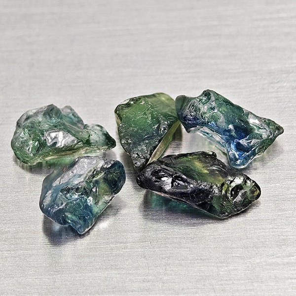 Natural Greenish Blue Sapphire Gemstones 4.87 Ct. 5 Pcs. Rough Shape Mixed Size: Product ID: 806162515 Product Name: Natural Green Sapphire Weight: 4.87 CT. Size: 6.7 x 4.9 x 4.4 to 9 x 5 x 3 MM. Shape: Rough Mixed Shape Color: Greenish Blue Clarity:VSI Luster: Good Gems Origin: M