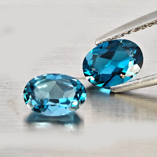 Natural London Blue Topaz Gemstones 1.68 Ct. 2 Pcs. Oval Shape 7 x 5.2 Mm.: Product ID: 807169108 Product Name: Natural Blue Topaz Weight: 1.68 CT. Size: 7 x 5.2 x 3 MM. Shape: Oval Shape Color: London Blue Clarity:VSI - SI1 Luster: Good Gems Origin: Brazil Treatment: Treated