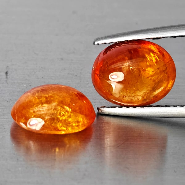 Natural Orangish Red Spessartine Garnet Gemstones 8.12 Ct. 2 Pcs. Oval Cabochon Shape Mixed Size: Product ID: 802938012 Product Name: Natural Garnet Weight: 8.12 CT. Size: 10 x 8.5 x 4.5 to 10 x 8 x 5 MM. Shape: Oval Cabochon Color: Orangish Red Clarity:SI1 Luster: Good Gems Origin: Namibia Treatm