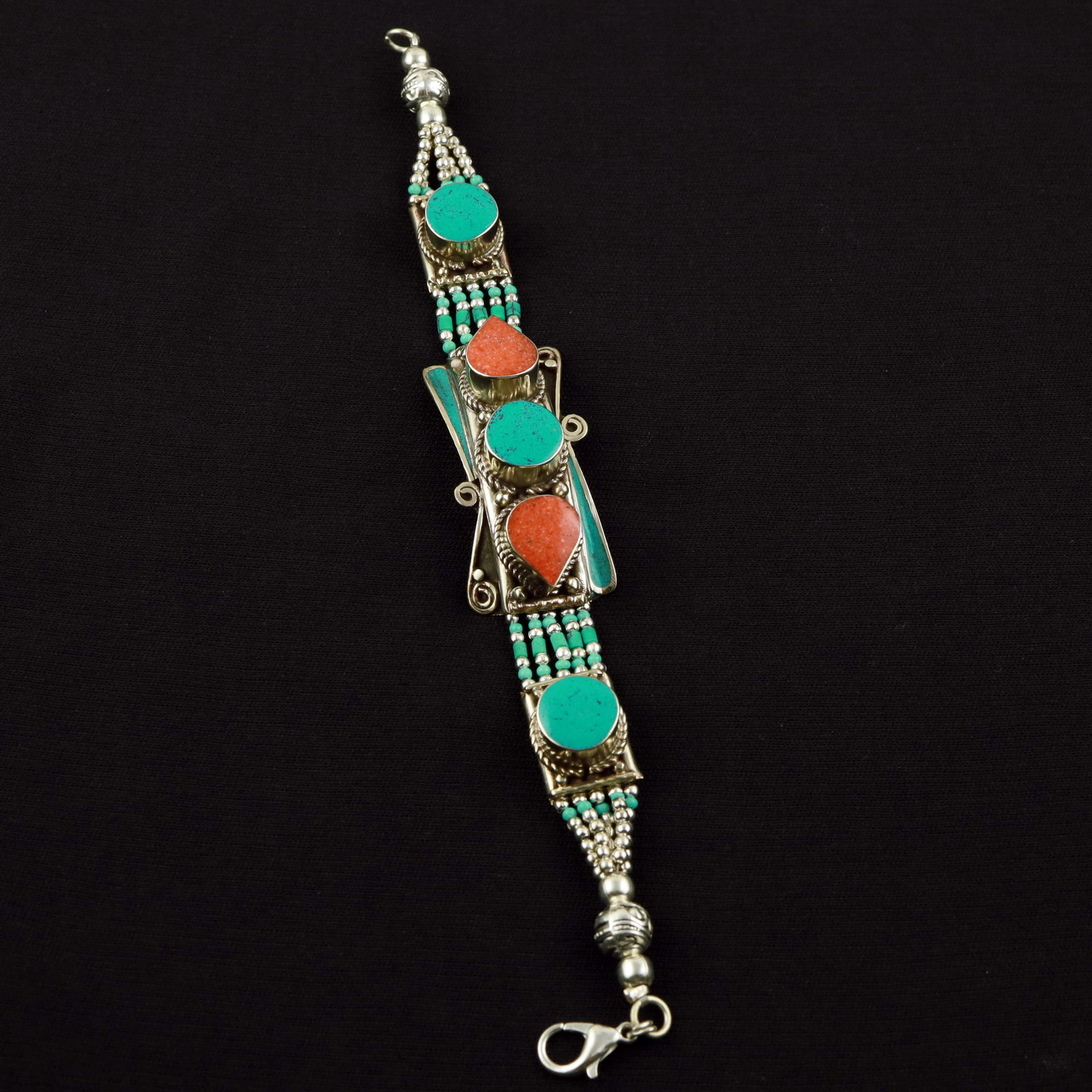 Tibetan Turquoise & Coral Handmade Designer Bracelet: Product ID: 260520114540 Product - Tibetan Handmade Ethnic Bracelet Gemstone - Natural Turquoise & Coral Size - 7 Inch Weight - 50 Gram Approx Metal - Brass & Copper mix Metal Origin - Nepal Country/R