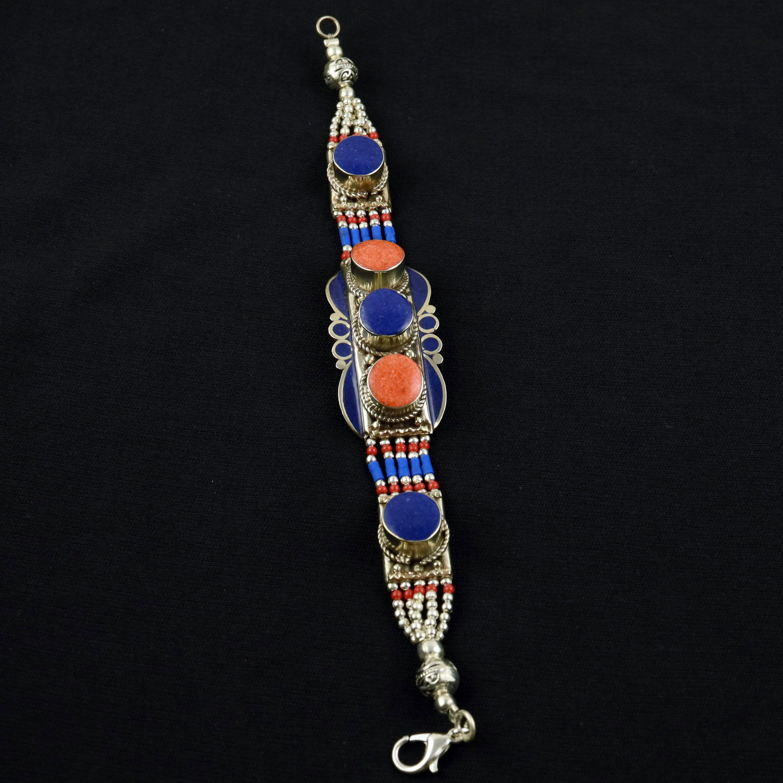 Afghani Lapis Lazuli & Red Coral Handmade Designer Bracelet: Product ID: 260520120044 Product - Tibetan Handmade Ethnic Bracelet Gemstone - Natural Lapis Lazuli & Coral Size - 7 Inch Weight - 50 Gram Approx Metal - Brass & Copper mix Metal Origin - Nepal Countr