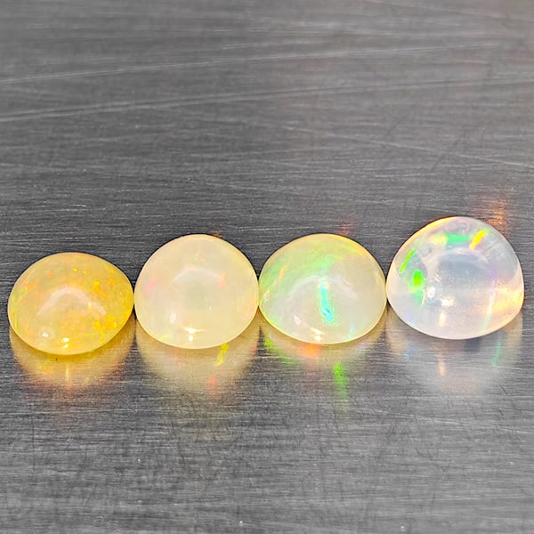 Natural Multi Color Opal Gemstones 1.76 Ct. 4 Pcs. Oval Cabochon Shape 5.6 x 5.2 Mm.: Product ID: 818728392 Product Name: Natural Opal Weight: 1.76 CT. Size: 5.6 x 5.2 x 2.9 MM. Shape: Oval Cabochon Color: Multi-Color Clarity:Semi - Transparent Luster: Good Gems Origin: Ethiopia Treatm